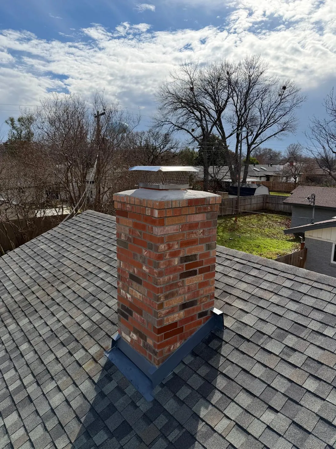 Chimney after full brick rebuild with new crown and stainless steel cap — Dallas TX