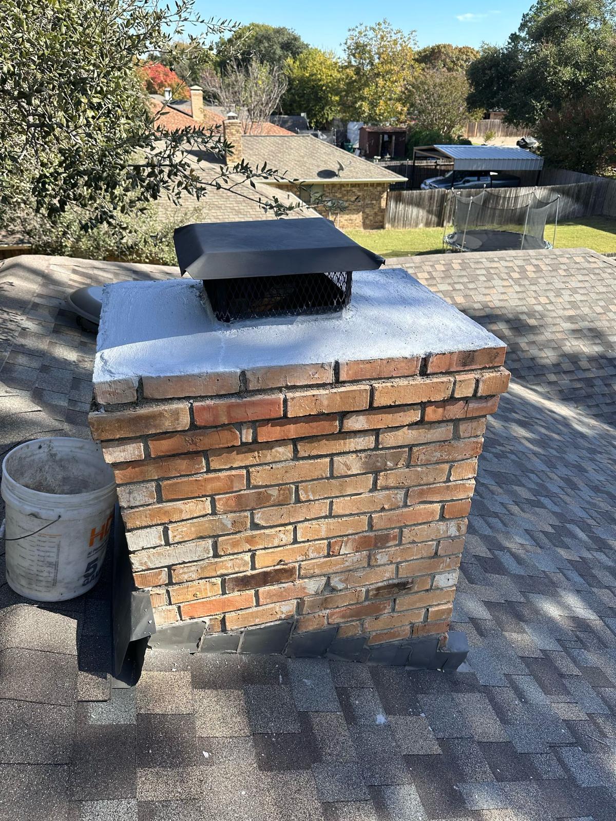 Chimney after crown resurfacing and new black galvanized cap installation — Dallas TX