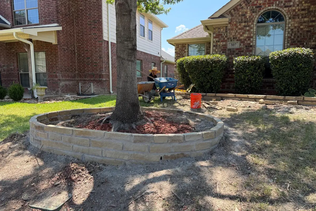 Flower bed after — fresh mulch and stone border landscaping — Dallas Fort Worth TX