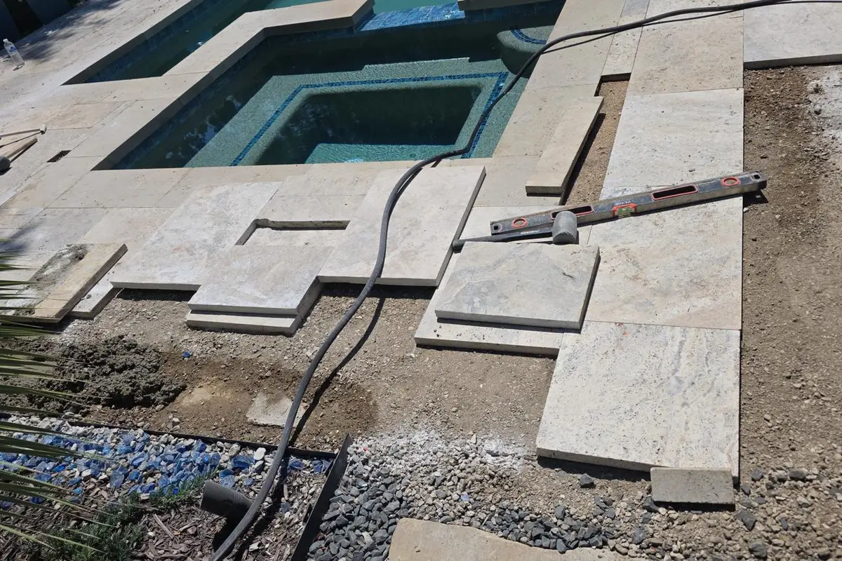 Pool deck before travertine pavers — bare concrete and sub-base — Dallas Fort Worth TX