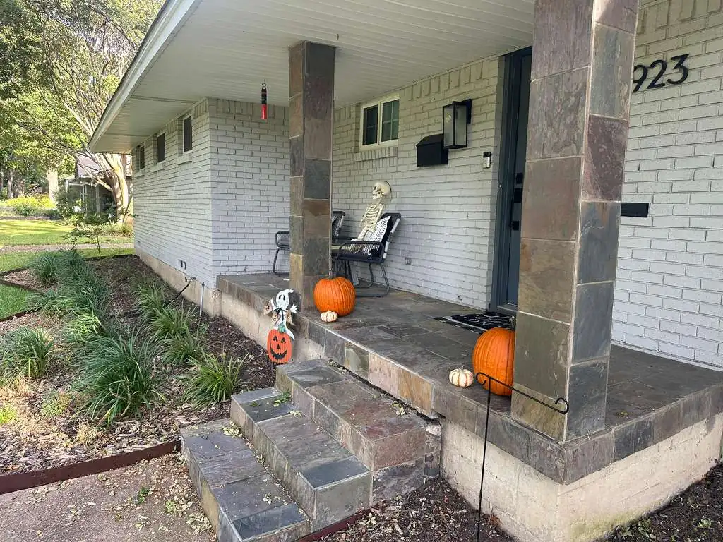 Front porch with plain painted columns and brick steps — before masonry upgrade