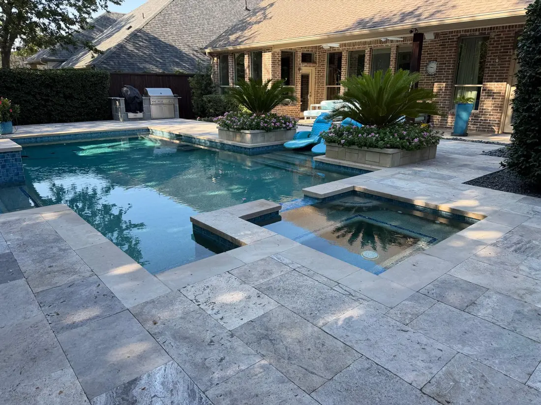Finished travertine paver pool deck and house Dallas Fort Worth TX
