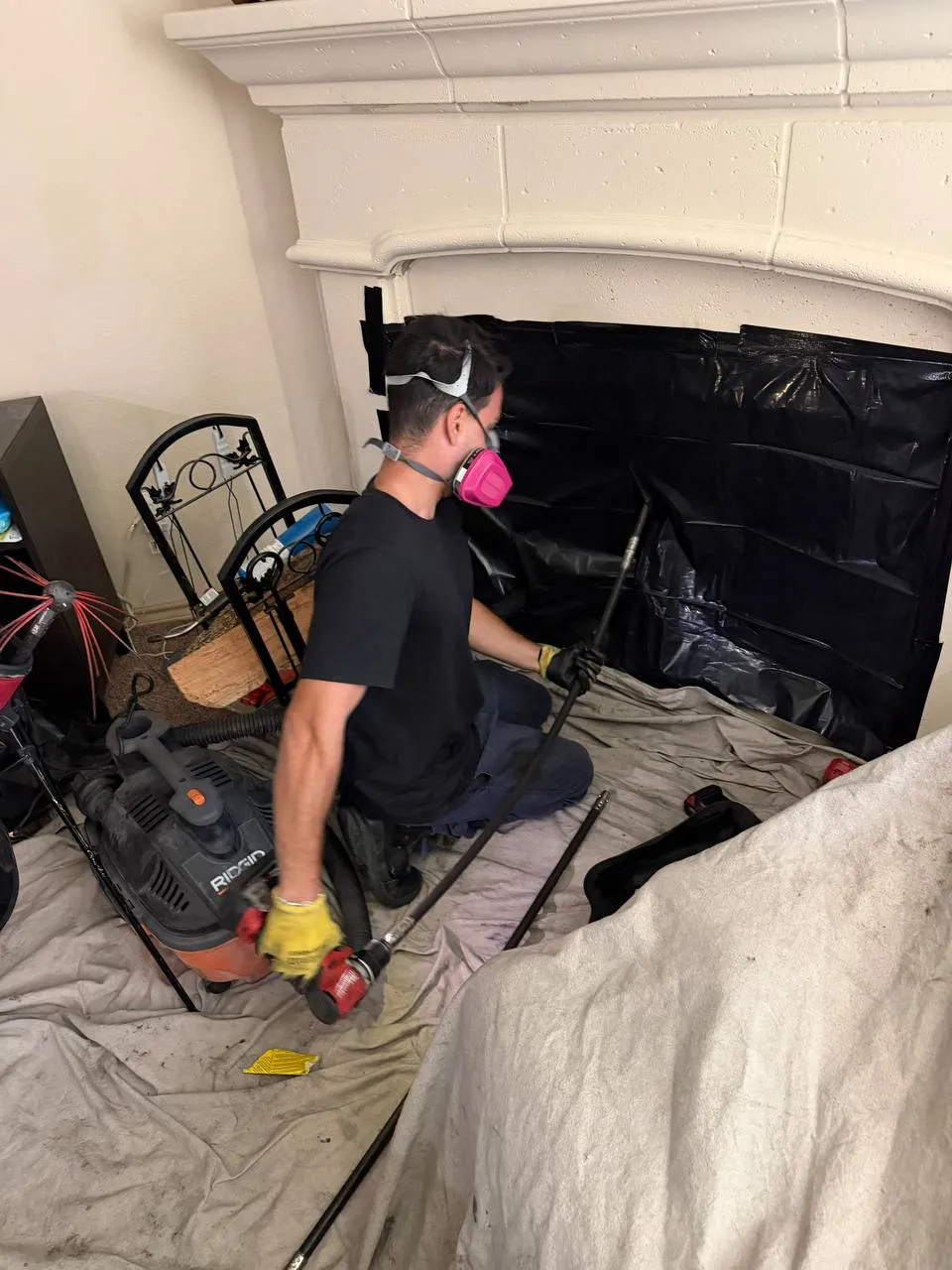 Preston Home Services technician cleaning a residential fireplace and chimney
